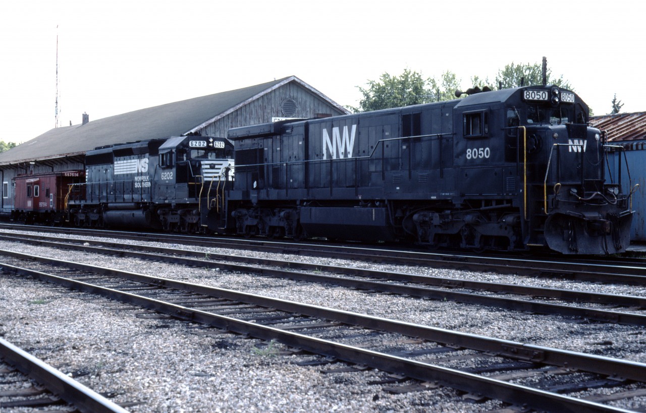 Here we see a set of Norfolk Southern units (a C30-7, still in N&W paint, and an SD40-2), next to the former freight shed which housed staff for the Wabash/N&W/NS-CN "Joint Section" into the 1990s. Trains operating over the Cayuga and Chatham subs would drop their traffic at Talbotville, about 4 miles to the west, and then tie up here with their caboose.