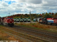 7 Trains, three builders (MLW, EMD, GE), in a single shot - With OSR pulling ahead switching cars in the Goderich yard and a CP eastbound just around the corner, my timing couldn't have been better. It was a Sunday so all the GO trains were parked in the yard giving me my props. I managed a few 'multiple train' photos from Bert Eliander's house on his hillside but this was one of my best. What makes it for me is the Shortline action - this is the shot I wanted and was the hardest to get - usually by the time OSR was on duty in the morning all GO trains were gone and weekend extras weren't very common.  Nikon D70, 50mm f/1.8 prime.