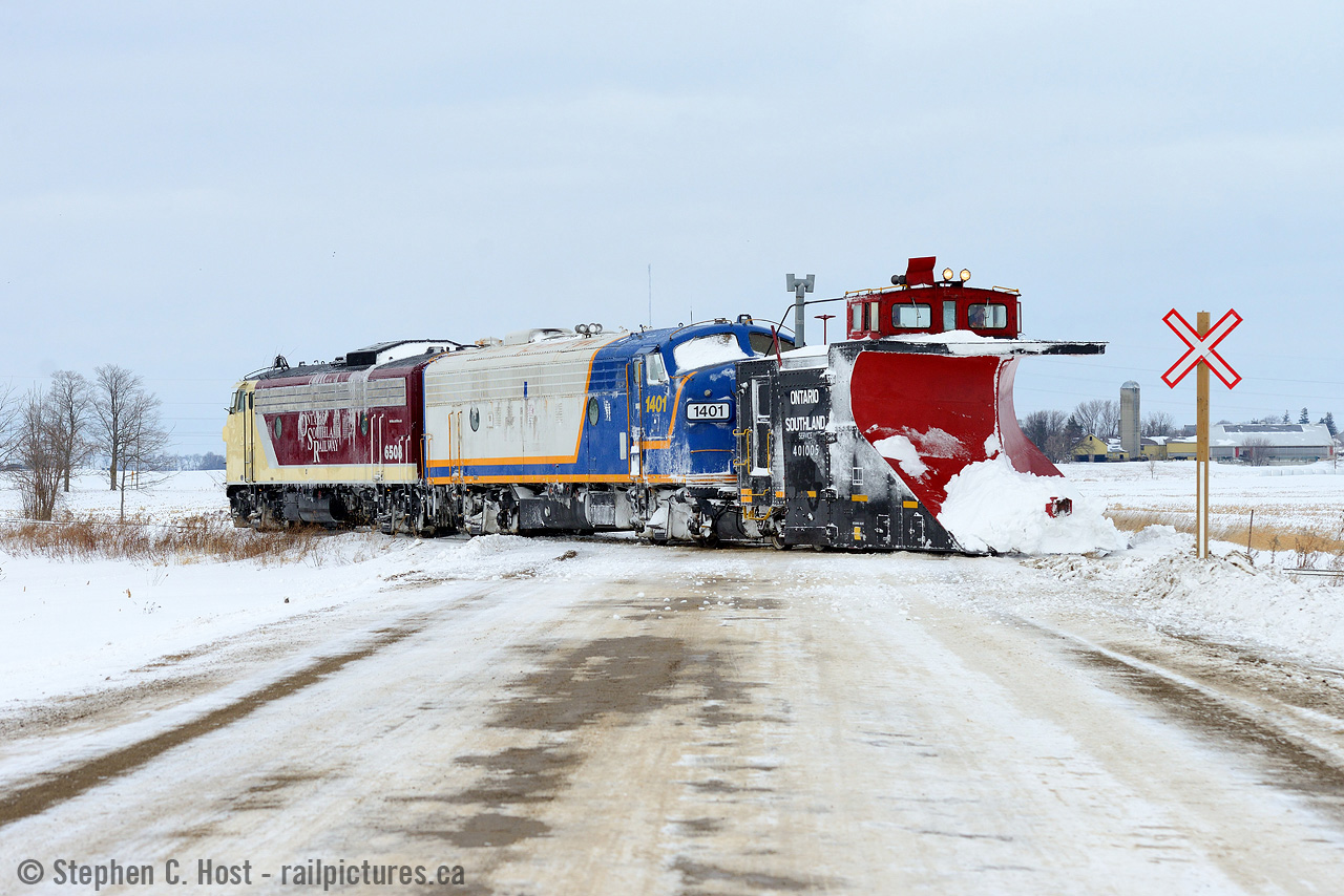 So earlier this morning I bet on two horses out of Stratford and I was headed to Goderich following a GEXR plow extra when I got word from a friend (With great thanks!) OSR was plowing. Three years to the day of something I never thought i'd be able to do again, so I had to find a way to do it. OSR started plowing the St. Thomas subdivision in the morning and the Port Burwell was next after a deadhead back, and I figured they'd take the Port Burwell around noon. Thing is, I only had a half day off and had to get back to work, so I cut off my GEXR chase near Clinton and went straight to Salford. I watched OSR plow the piss out of the Salford cut, then set up for shots at the De Bruyn farm where drifting was particularly heavy. After getting some good action shots there was a problem - a bolt snapped in the OSR's wing system and crew decided to reverse to the Salford shops to try to repair before proceeding to Tillsonburg. My chase was over and I decided to snap one last photo of the overall scene (above) - many of us have posted tonnes of photos of the business end of plows doing their thing, but sometimes it's nice to see the motive power instead
I had high hopes for some good action this winter and have been scoping things out already - I've made two trips to Stratford and two to Salford already, and came back empty handed more than once, but made up for it in spades on Tuesday. Thankfully, I bet on the right horses.