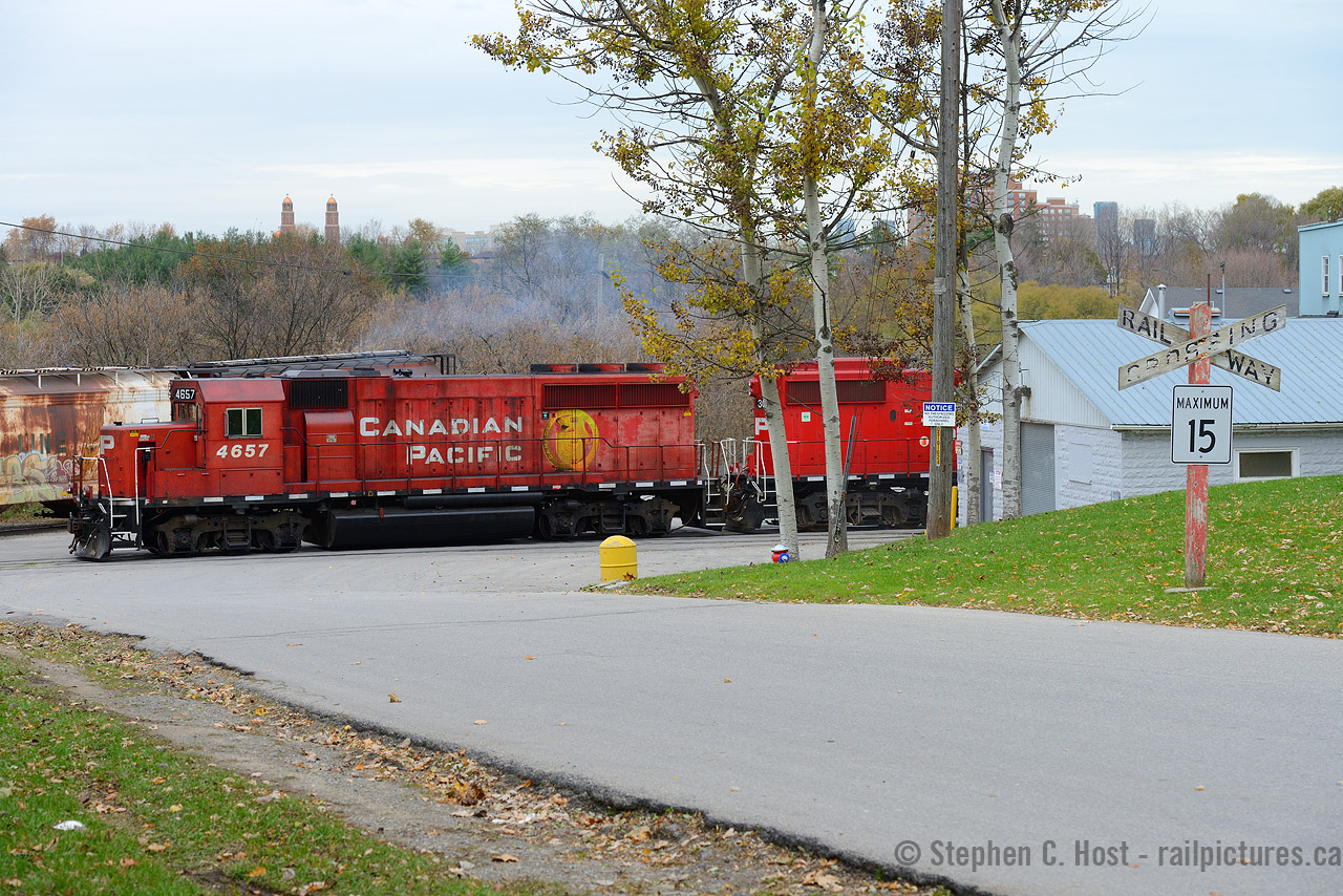 And a shot that took years of planning and patience, having missed the ability to photograph any train near an old-school wooden Crossbuck in my youth (Most were replaced by the time I came of age) I was yearning for the opportunity to do so, and here it is.  Given the timing for this job in the day, I had to settle for an overcast day as it was usually a morning train which would have totally backlit this scene if sunny. Also of note, while taking this photo, the Manager of this (at the time) ADM facility was standing beside me because I wasn't apparently allowed to take photos OF their property (Not true, I can take photos of what I want, from public property, it's the law). I stood my ground and took my photos and did not tresspass. It was a very unpleasant experience but I got what I wanted. There was also a public trail but I didn't want to push it, this guy was a real asshole and would simply follow me on foot. Lucky for me, T15 had a rather interesting GP40 for a leader - is 4657 still with us? Needless to say I never tried again after this :)