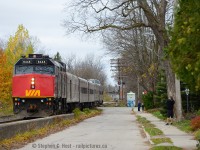 A dome car in Guelph? Well, this wasn't your average VIA Train. This was the Grey Cup display train reversing to take the former CNR Fergus sub to get to downtown Guelph on the Guelph Junction Railway (phew!). Also, RP.CA member Dan Tweedle is seen taking photos and here's <a href=http://www.railpictures.ca/?attachment_id=6215 target=_blank> his photo posted on rp.ca </a> <br><br>
I never told this story until now, but I had a hand in this train coming to Guelph. With the CFL train being painted in Mimico and word got around to what was coming - we got in touch with the folks at the <a href=http://www.railpictures.ca/author/greycuptour> CFL - click here for their rp.ca profile</a> and through this site, the folks at the CFL were interested in promoting it. The CFL folks posted the first shots of this train here for everyone to see. The CFL Marketing team were ecstatic to see such a great response to their Grey Cup Train on their photo profile . I also recognised that there was a nearly two week break in their schedule in the GTA and suggested, kindly that they consider a Guelph stop - I mentioned I could put them in touch with the right people to make it happen, and they were interested in a downtown Guelph stop but it couldn't be on the mainline due to all the train traffic - it has to be on the GJR. The level of interest from the CFL was incredibly high and I didn't realise why until later. Being on the Guelph Junction Railway board at the time, I got in touch with then General Manager Tom Sagaskie and after the Guelph Junction Railway and the Ontario Southland Railway were on board with the project Tom put everything into motion. GEXR got involved as they had to co-ordinate pilots for the move to/from GJR as well as the train's schedule on the Guelph sub, and of course VIA was involved as it was their equipment. VIA 84 dropped the train off in the morning (it was on the rear of the train) and the train was scheduled to be lifted by #87 in the evening (unless it ran extra, I wasn't around to see it go). VIA supplied an extra crew for the short GEXR and GJR move as well to babysit the locomotive while on display. OSR supplied their own pilot (Brad Jolliffe, who is now Operations Manager in Salford). Even CN and Metrolinx were involved in this move in some capacity.  I posted a photo of the entire crew <a href=http://www.railpictures.ca/?attachment_id=7765> here back then </a>. The Guelph Historical Railway Association provided volunteers to help people board and get off and provide crowd control, and the event went off without a hitch! <br><br> I was still surprised how quickly all of it was put together and thankful for the hard work by all involved - it was no small feat. The thing was, Guelph was soon to be announced as the temporary home of the Hamilton Tiger Cats while Ivor Wynne stadium was undergoing renovations and I suspect they hoped to announce it before the CFL event but it was announced a week or two after the fact. (The delay was due to negotiations with the University of Guelph). There was method to their madness and they wanted to get some good PR for the 2013 season. The only regret is this was all put together with mere weeks to the event and  more time would have brought more awareness- but the newspapers, radio, and social media got the word out locally and we had a few thousand visitors downtown. It takes a lot of people to pull something like this off, and I appreciate how we can rely on each other to ensure events like this go off without a hitch.
<br><br>
I know a number of people on this site have been involved in arranging excursions and display trains (<a href=http://www.railpictures.ca/author/r-l-kennedy>Ray Kennedy's 1960 triple header </a> to Orangeville probably being the most famous! - You guys realise Ray was 18 years old when he did all of that?). You young-ins should think about this and get involved with your local railway club - Clubs like the <a href=http://www.ghra.ca</a> GHRA </a> who have organised excursion trains every few years are great outlets for getting involved - and if you have big ideas, there are people who are willing to make it happen. Join one today!

