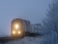A very late running VIA, approximately 35 hours, is given a clear run from Wainwright to Edmonton.  Seen here pushing its way through the ice fog at Bruce.