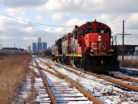 After switching Hiram Walker & Sons distillery on Windsor's waterfront, CN 7046 & 4135 head down the Chatham Sub. with a single tank car as they snake their way through the city eventually making it to Van de Water Yard. CN gave up this job during the summer of 2012 however the Essex Terminal picked it up and now switch the distillery.