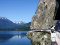 Running along Anderson Lake on our northward journey on the former BC Rail the train is sneaking along the "dry slide", the terrain is rugged straight up and straight down. I could hear the "ohs and ahs" of the passengers enjoying this spectacular scenery. The locomotive is at mile 126 and this area has a 15 mph speed restriction "until track is seen to be clear". Most crews approached this area at about 10 mph. The curve behind the dome car is a tight 13 degree. 