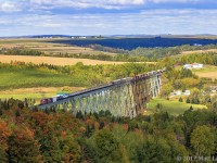 CN 2665 leads an X474 eastbound, as they cross the 3,920 foot Salmon River Trestle in New Denmark, New Brunswick on a cool Fall afternoon. The leaves are just starting to change color in this area. A week later, there would have been a beautiful display of Fall's colors. 