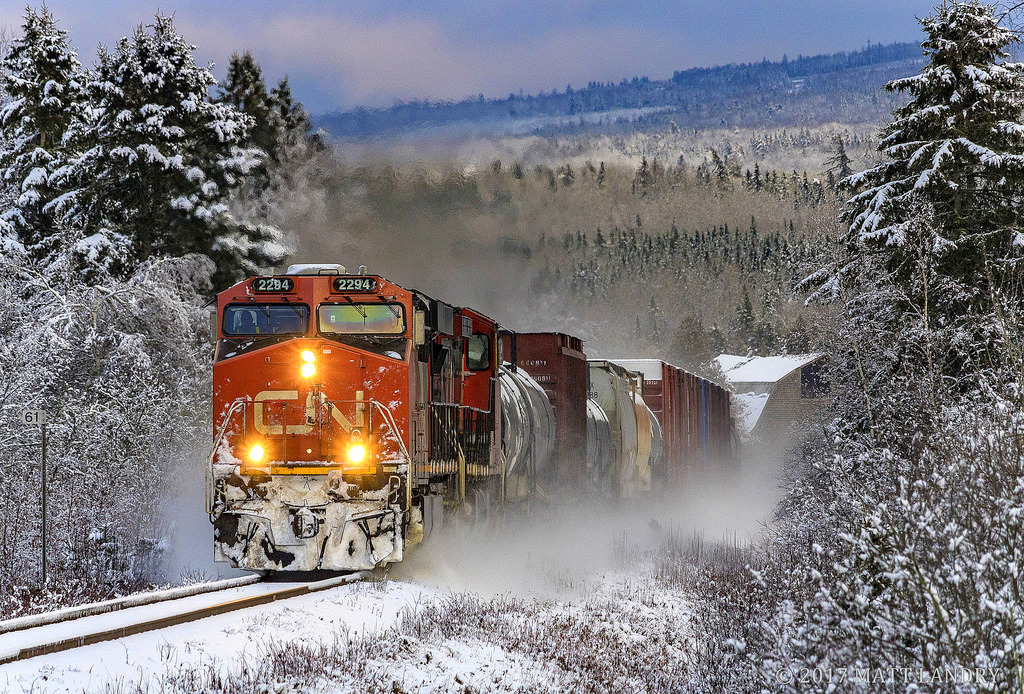 After the first big snowfall of the season, westbound train 406 heads through the nice snowy scene at Passekeag, New Brunswick.