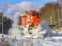 CN 8915 leads CN Train A406, as they rumble through a snow bank at the crossing in Rothesay, New Brunswick, the day after the area received 15-20cm of snow. Great to see the sun make an appearance too. 