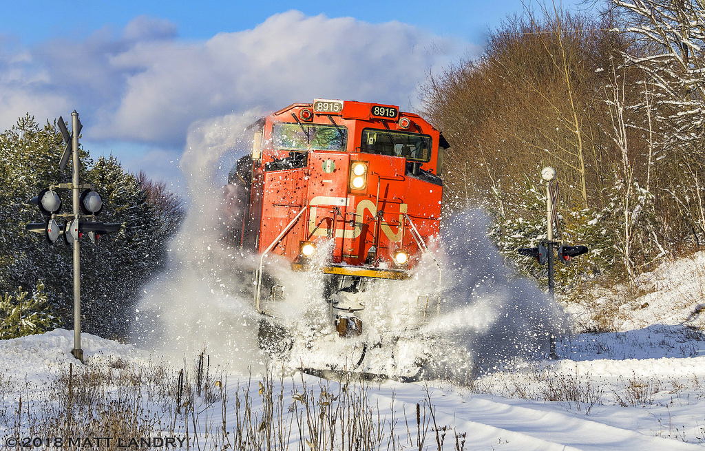CN 8915 leads CN Train A406, as they rumble through a snow bank at the crossing in Rothesay, New Brunswick, the day after the area received 15-20cm of snow. Great to see the sun make an appearance too.