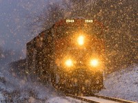 With another day almost done, and the snow starting to fall, westbound 406 approaches Hampton, New Brunswick. 