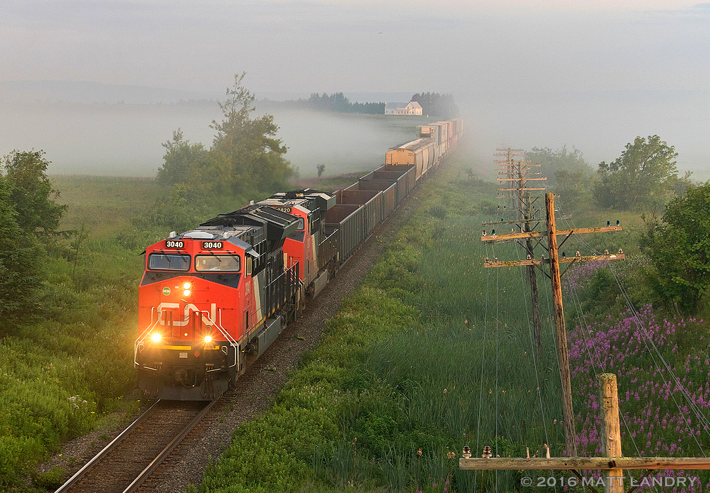 Coming out of the fog, CN 120 crosses over the New Brunswick / Nova Scotia border, approaching Amherst, Nova Scotia. A few minutes after this shot, the sun finally came out.
