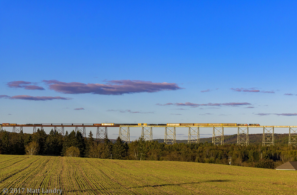 In some late Fall evening light, eastbound train M306 crosses the massive Salmon River Trestle, at New Denmark, New Brunswick. The bridge stands at 3,920 feet in length, and as far as I know, is the second longest in Canada.