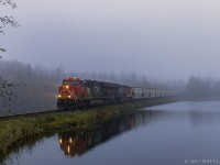 In some thick fog, CN B730 passes by the lake, as they start their descent down into Saint John, New Brunswick.