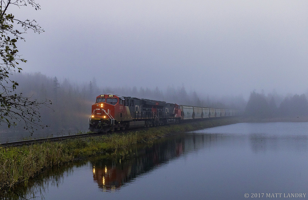 In some thick fog, CN B730 passes by the lake, as they start their descent down into Saint John, New Brunswick.