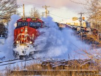 After the first major snowstorm of the year(On Christmas Day, no less), dumping 20-25cm of goodness, westbound train 406 hits a nice pile of snow at one of the crossings at Hampton, New Brunswick. 