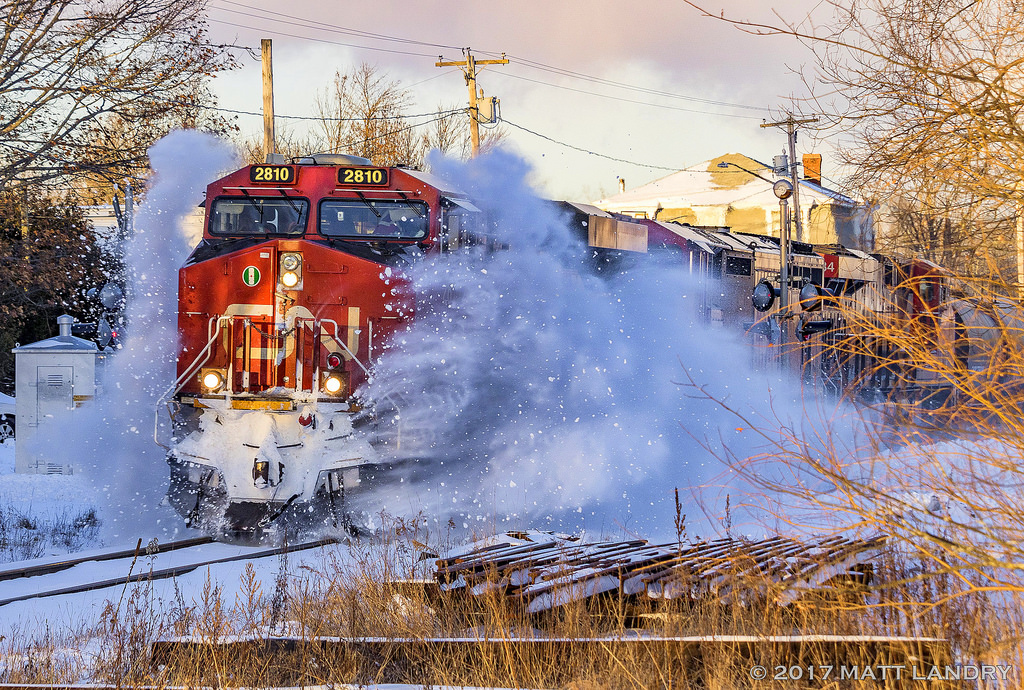 After the first major snowstorm of the year(On Christmas Day, no less), dumping 20-25cm of goodness, westbound train 406 hits a nice pile of snow at one of the crossings at Hampton, New Brunswick.