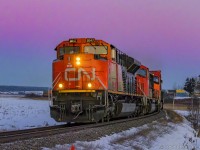 CN 8947 leads stack train Q120, as they round the bend at Upper Dorchester, New Brunswick, shortly before the sun peeks up over the horizon, with some great colorful lighting before hand. 

