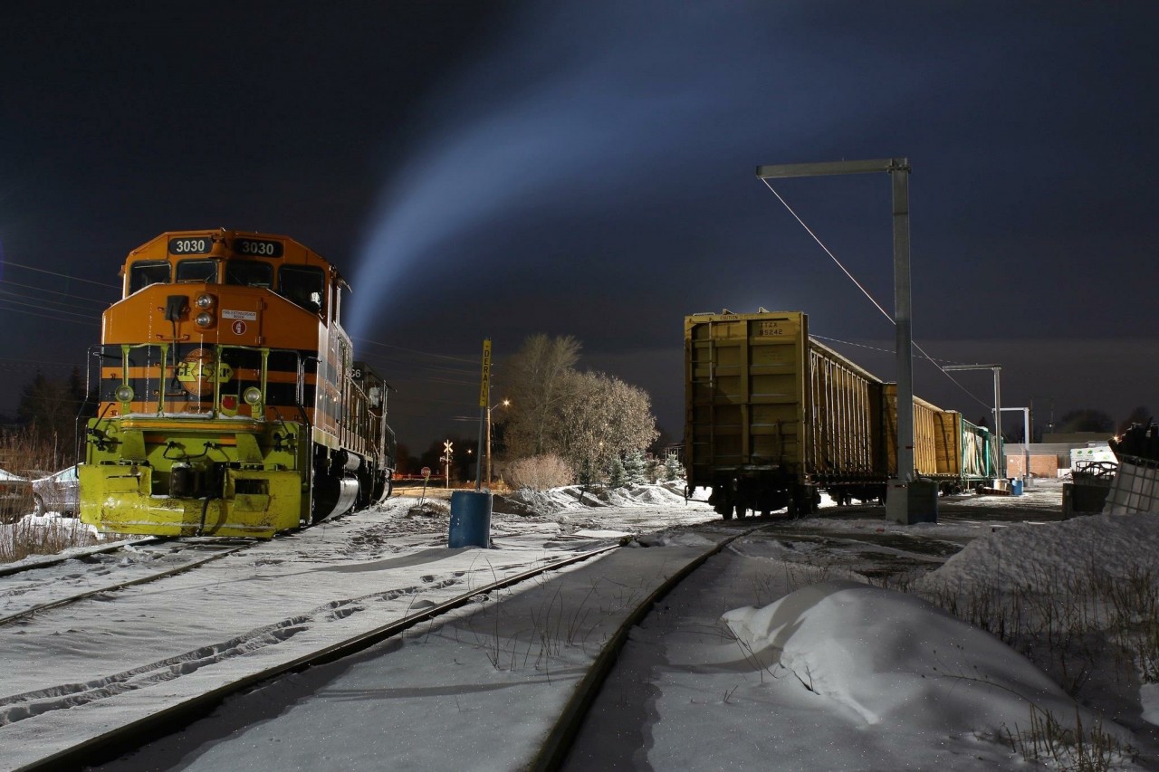 Mechanical issues forced GEXR train 582 to spend the previous night outlawed in Guelph. Tuesday night the train finally made its way home to Cambridge. Here we see former CN GP40W 3030 on former CN rails waiting out the night at the lumber yard with GP38 #2236 idling away in the bitter cold behind, awaiting the mornings call to duty, and yet another trip back to Guelph. The lighting at a car dealership and the lumber yard do a lot to aid night photography here.