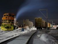 Mechanical issues forced GEXR train 582 to spend the previous night outlawed in Guelph. Tuesday night the train finally made its way home to Cambridge. Here we see former CN GP40W 3030 on former CN rails waiting out the night at the lumber yard with GP38 #2236 idling away in the bitter cold behind, awaiting the mornings call to duty, and yet another trip back to Guelph. The lighting at a car dealership and the lumber yard do a lot to aid night photography here. 