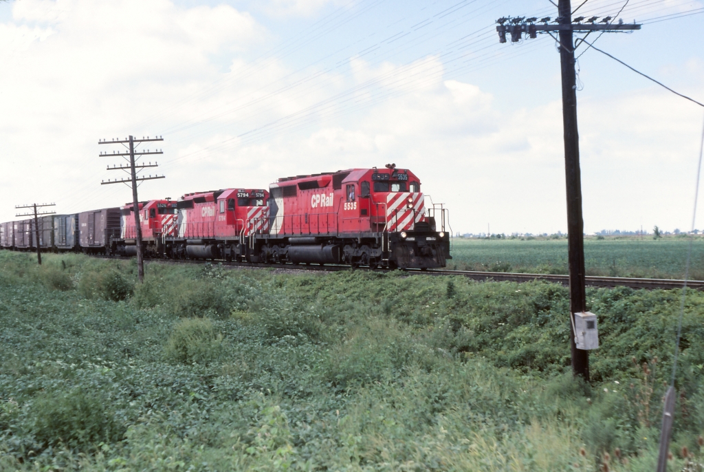 CP 5535 with 5794 & 5526 elephant style heading east near Chatham. Sorry I do not have the exact location, train number etc. I'm sure the fellow that was standing there with me might be able to recall from his well kept notes the date, train number, number of cars as well as the caboose number.