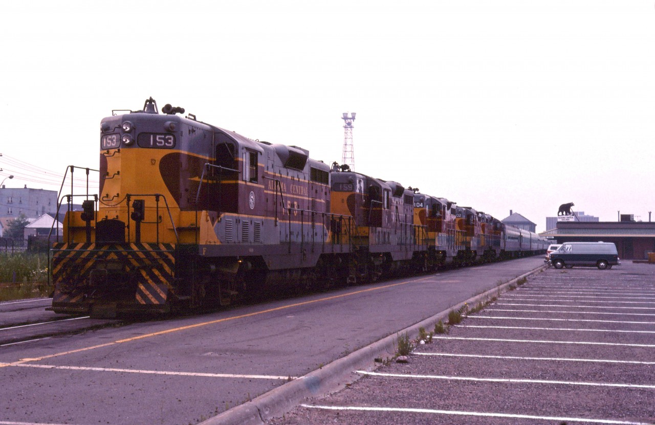 The Agawa Canyon tour train at the ACR's Sault Ste. Marie station in the summer of 1979 with a 5 unit GP7/GP7 rebuild lash-up (153, 154, 104, 102 and 103).