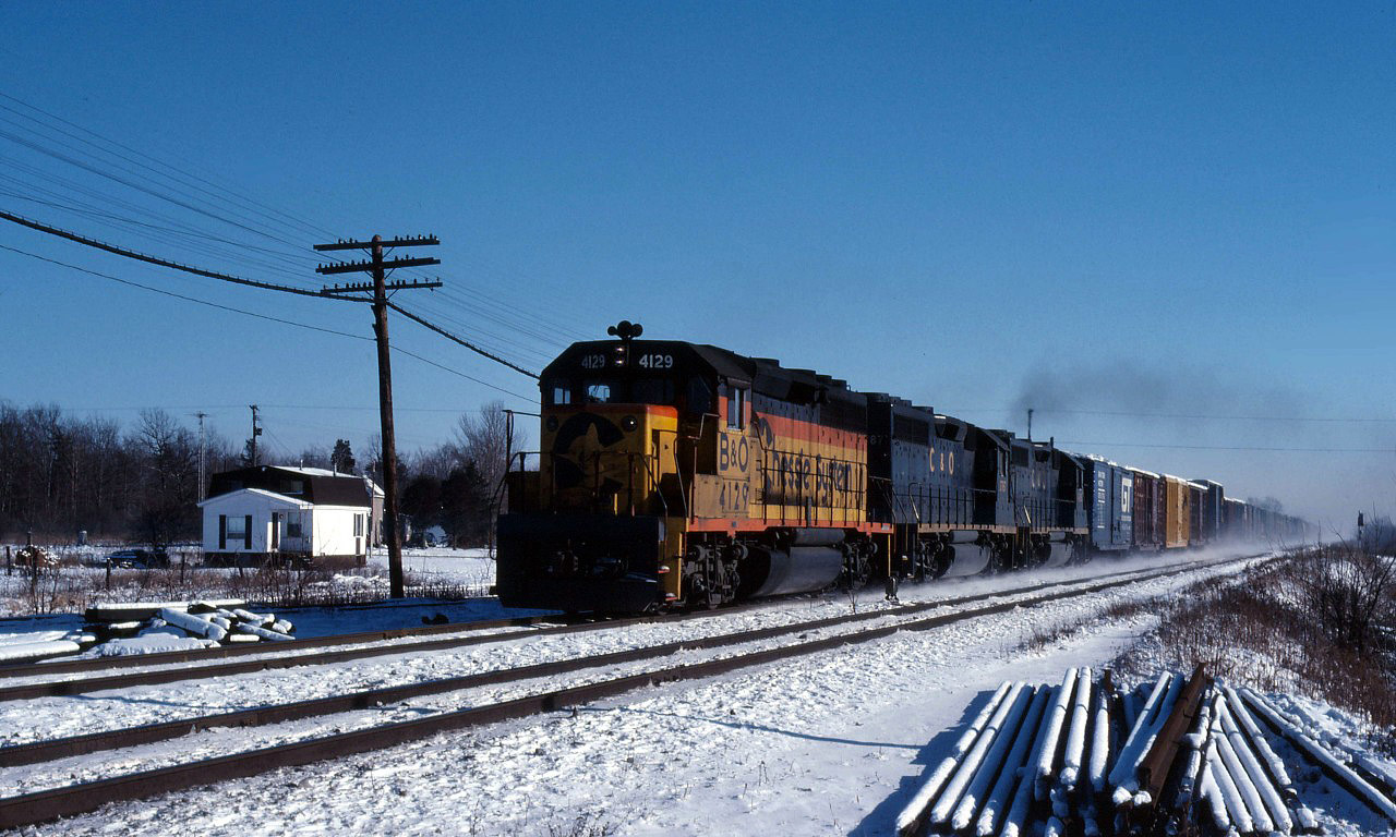 A Baltimore and Ohio GP40-2 leads a pair of Chesapeake and Ohio units through Canfield on a westbound freight in January 1979.