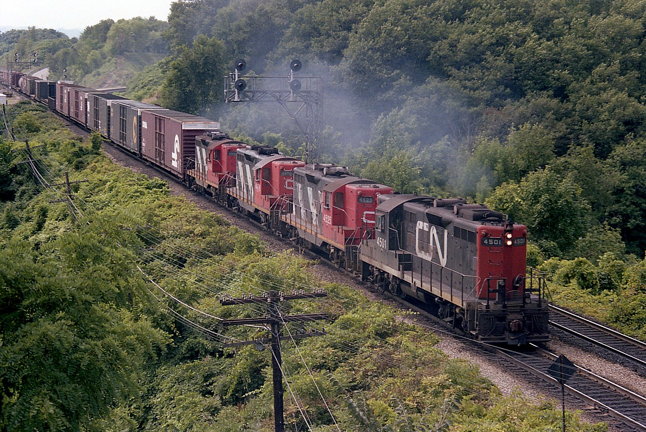 Here's a wonderful set of old GEEPS bound for Toronto from Fort Erie on a warm August day. I'm standing on the side at the Railfan's Walkbridge, as we call it and the foursome of CN 4501, 4525, 4576 and 4592 is a classic collection of power of which a considerable number of those GP 9s used to be maintained at  Fort Erie. They were a favourite locomotive of mine for pictures over many years.