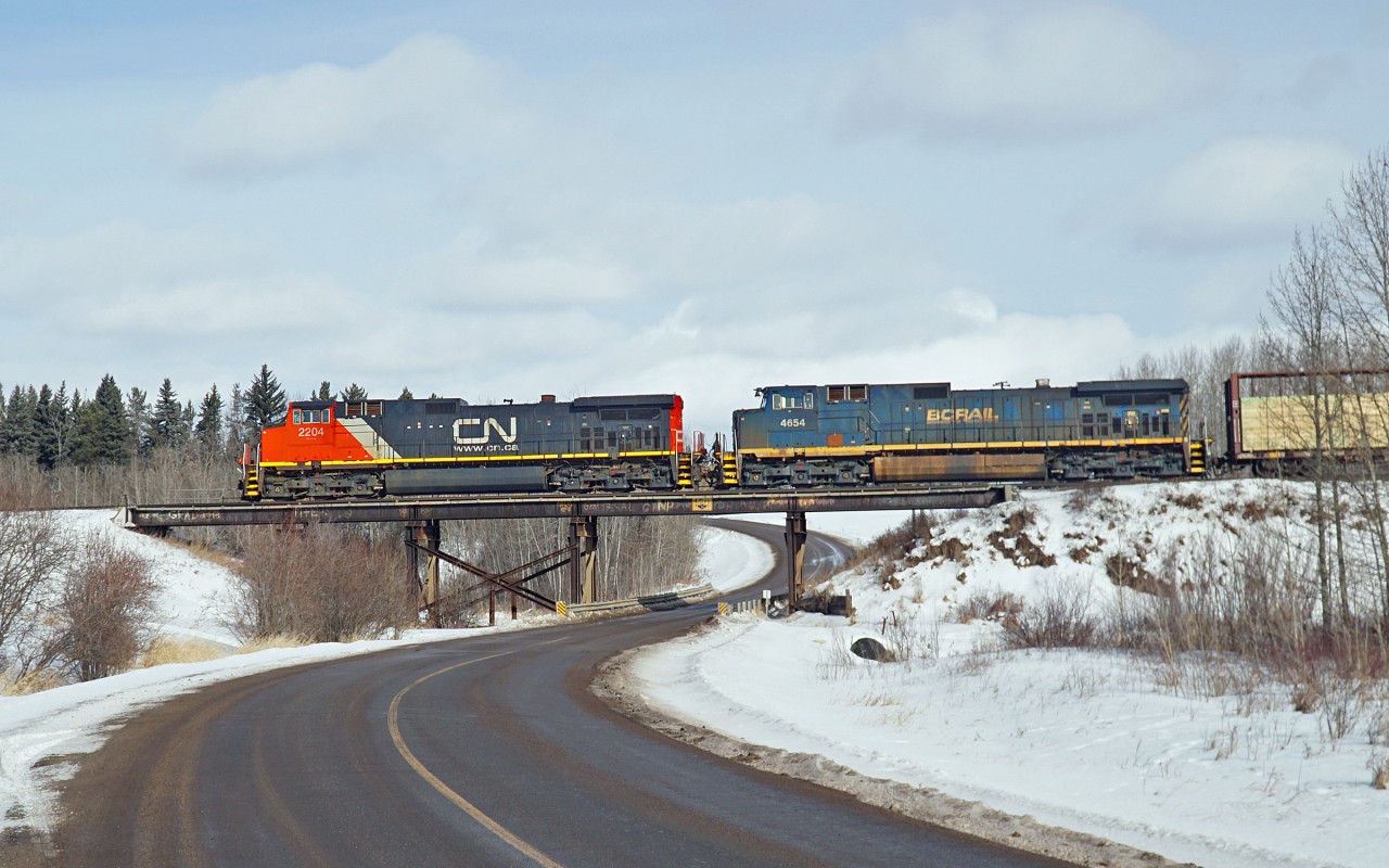 CN 2204 and BCOL 4654 cross Range Road 225 on their approach to Clover Bar and Edmonton.