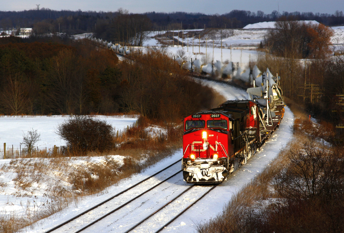 CN X311 peaks through a nice sucker hole as they slow to a stop to let VIA 47 roll by on the north track.