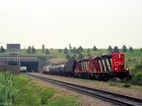 CN GP9RM 4142 and another sister rebuilt geep haul a short train westbound on the Cayuga Sub, pictured coming out of the west side of the Welland Canal.