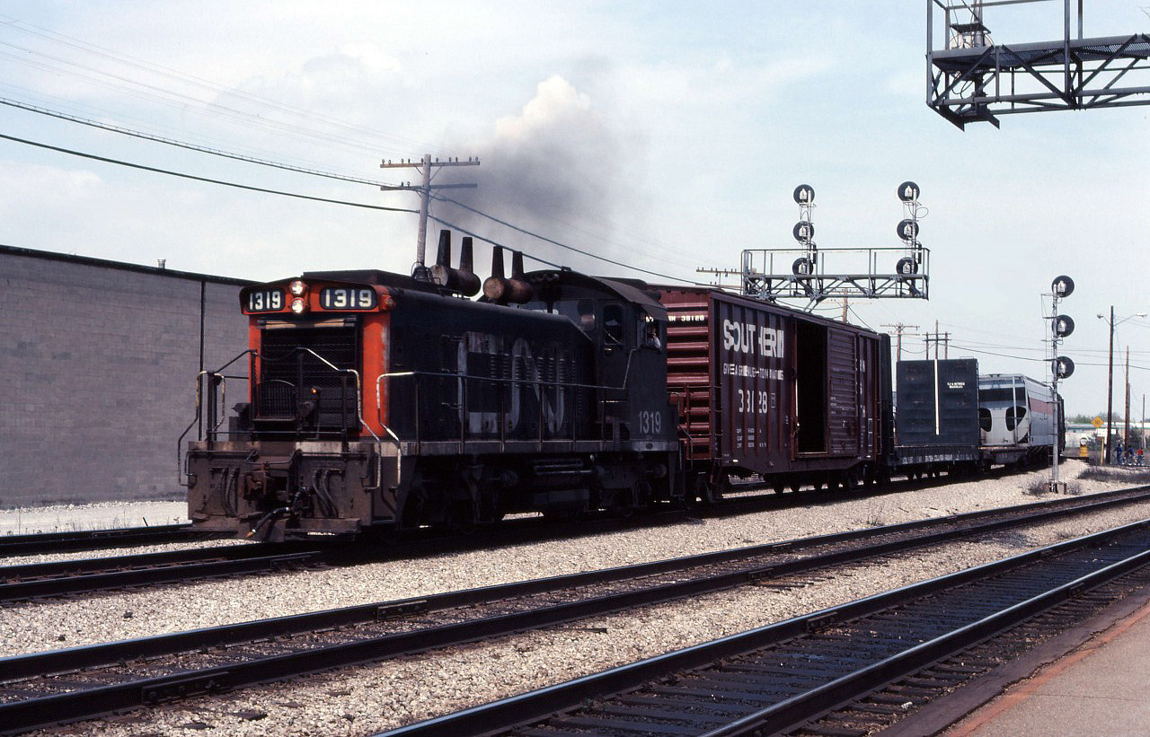 SW1200RS 1319 leads the way freight through Burlington after switching industries on the Halton sub. Over the years, at times this train originated in Burlington (with power and van deadheading to Hamilton for servicing) and, at other times, it originated at Stuart Street Yard and ran to Burlington.