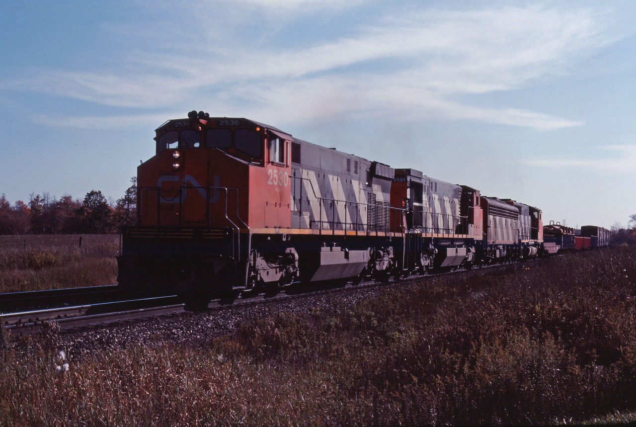 In what looks like a late fall shot (processed in January 1985), we see a Canadian National eastbound moving through the rural part of Burlington. 2530 was the first unit in CN's second order for M420Ws back in 1974. It is trailed by 1981-built HR412 2581, F7Bu 9195, and GP40-2LW 9434.
