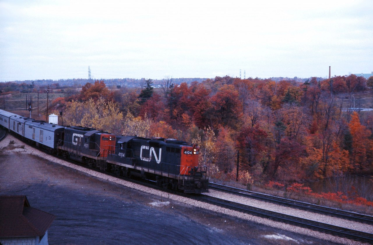 In the early 1970s, CN regularly assigned GP9s to passenger service in southwestern Ontario. Today, we have a bonus--leased GTW passenger GP9 4921 accompanying CN GP9 4104 on an eastbound passenger headed for Toronto. Note the generator equipped baggage car which provided HEP (head end power) to the Tempo coaches.