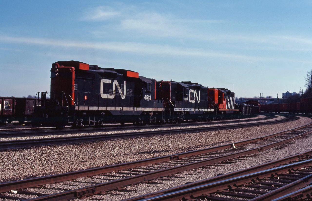 A CN eastbound powered by three GP9s (4513, 4527 and 4560) works Hamilton Yard on a spring 1981 afternoon.