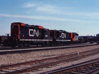 A CN eastbound powered by three GP9s (4513, 4527 and 4560) works Hamilton Yard on a spring 1981 afternoon.