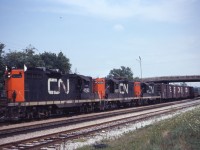 Into the early 1980s, GP9s were common power on CN freights to and from the Niagara peninsula. In this photo, we see Fort Erie-MacMillan Yard train 462 behind 4592, 4535 and 4527 passing Merritton station in St. Catharines. 