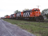 CN 208 rolls through Coteau with SD40 5079, M636 2336, and SD40 5080 on its Toronto-Halifax run.
