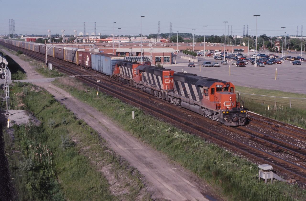 The hottest train on the Southern Ontario District at the time, CN 413 takes its run for "the hill" to McCowans on its way from Oshawa to Sarnia. Two "western" SD40s (5218 and 5029), as well as GP40 9314 power today's train.