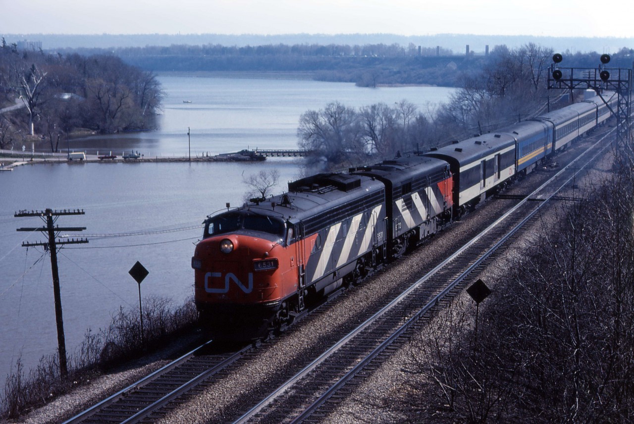 VIA took over passenger service from CN on April 1, 1978 and from CP on September 29, 1978. As you can see from this photo, while some cars were in "VIA CN" blue, many other cars and locomotives still had CN paint and markings after "Day 1". In this photo we see an eastbound train with FP9 6531 and FPA4 6772 accelerating away from Bayview (looking at the lighting, it is likely No. 76 from Windsor).