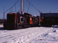 While many of us associate MLW S4 and GMD SW1200RS units with Hamilton yard duties; in the mid-1980s, 1200 hp SW9 and SW1200 units fulfilled that role (before the SW1200RSs were assigned to this service). Here we see two SW9s, 7704 and 7701, and another GM switcher on the west side of the Stuart Street diesel shop. These units have been renumbered from the 7000s, permitting GP9 units being rebuilt at that time to assume that number series. Also note the fuel delivery tank car.
