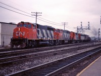 CN GP40-2LWs 9477 and 9654, lead RS18 3619, an F7Bu, a GP9 and an SW1200RS westbound through Burlington in an undated mid-1980s photo.