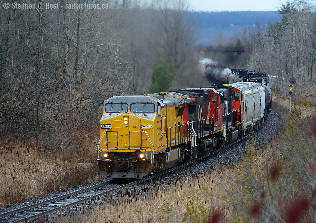 We knew when these leasers arrived on CN, there'd be a chance some of these rent a wrecks might end up in the lead - usually the wrecks are trailing only but a few slip the cracks in the lead. When they do, you've gotta stand up, for it could be quite rare. GECX 9130, ex UP 9369 leading M394 with 12,000 foot of train and 724 axles, climbing the grade at 18 MPH. With a train this heavy and power so 'tenuous' DI RTC made darn sure 394 had clear signals all the way up the Halton sub and no opposition - holding 385 at Stewarttown. With thanks to  Clint-o aka Loose Cannon  for the heads up at Paris, I was able to time it for my lunch break. The time is 12:45 PM. Here's to many more.