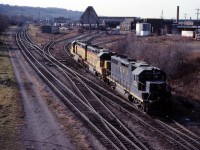 We are on the Chatham Street bridge as a trio of '38s back out of the TH&B roundhouse...likely headed for Aberdeen Yard to pick up the steel train. In the background you can see another leased unit (B&O), a CP Rail unit, at at least a couple of TH&B locomotives. While not classic TH&B, the early years of CP ownership certainly interesting.













