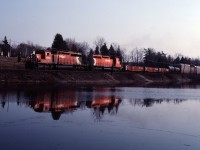 An eastbound approaches Guelph Line in Campbellville in the late afternoon with CP SD40-2 5909 and SD40 5561 for power.