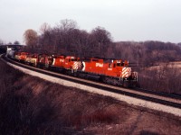 The winter of 1980-81 is over and once again a bright spring day draws us to Bayview. Our patience is rewarded as the Starlight comes around the curve with an interesting consist bound for the TH&B's Abereen yard in Hamilton. Behind CP SD40-2 road units 5935 and 5752, we have RS23 8023, GP7 76, SW1200RS 8157 and another TH&B GP7 returning from servicing at Toronto Yard.