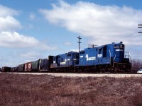 Beneath a Kodachrome sky, Conrail GP7 5284 and GP9 7438 work the CN interchange at Hagersville on their journey to St. Thomas.