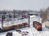 CN 149 has just left their train on the transfer track of CN's Montreal Sub, as the power (SD75I's CN 5732, CN 5742 & CN 5673) heads east light to lift a cut of cars left by CN 121 the previous night on CN's new right of way here, not yet in use for the most part. At left is a classic signal gantry whose days are numbered.
