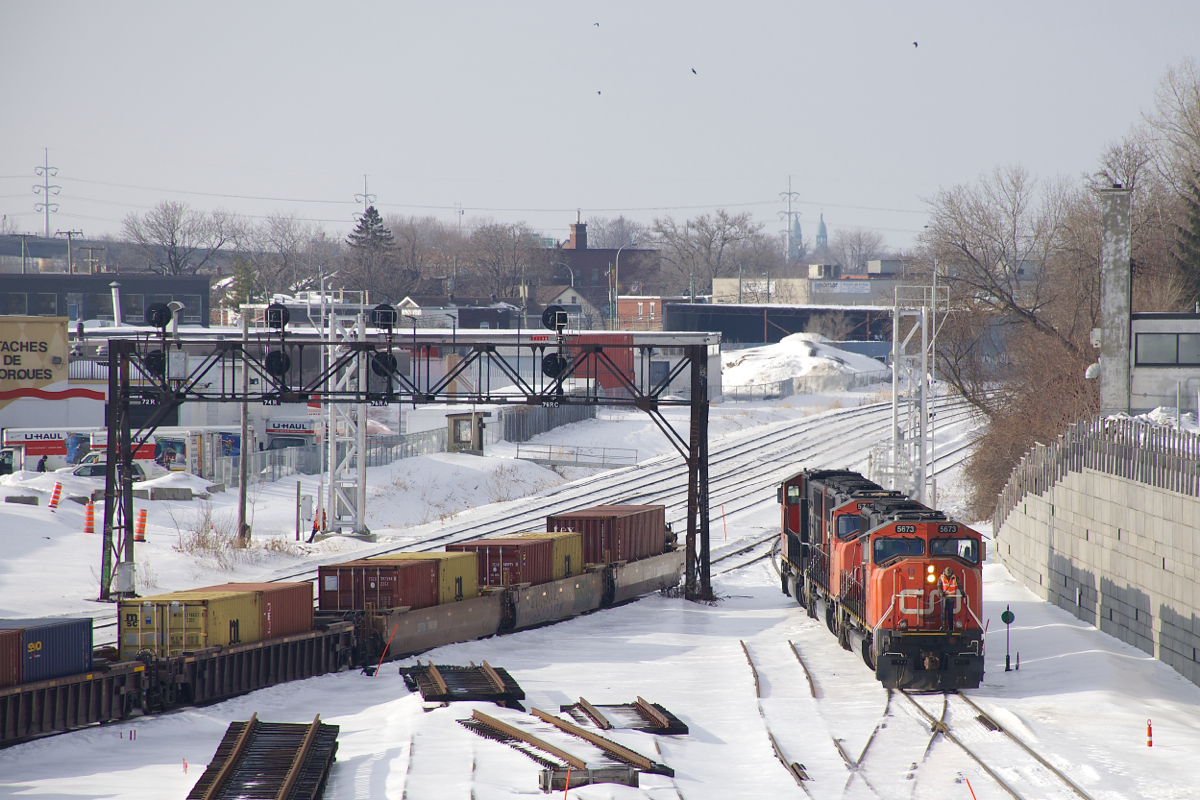 CN 149 has just left their train on the transfer track of CN's Montreal Sub, as the power (SD75I's CN 5732, CN 5742 & CN 5673) heads east light to lift a cut of cars left by CN 121 the previous night on CN's new right of way here, not yet in use for the most part. At left is a classic signal gantry whose days are numbered.