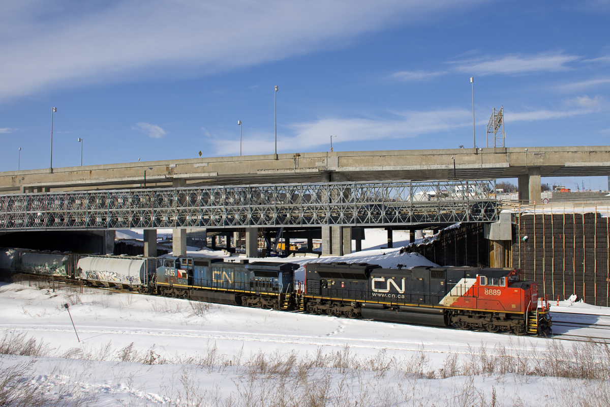 CN 8889 & IC 2455 lead a 128-car CN 310 underneath the soon to be demolished Turcot interchange.