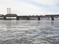 A lot of railways are involved as this SLR detour train has NS power lent to SLR by CN on CP tracks. Here SLR 393 crosses the St. Lawrence River on CP's Adirondack Sub with NS 8380, NS 9803 & NS 9448 from the CN 528/529 pool and 88 cars for CN's Taschereau Yard.