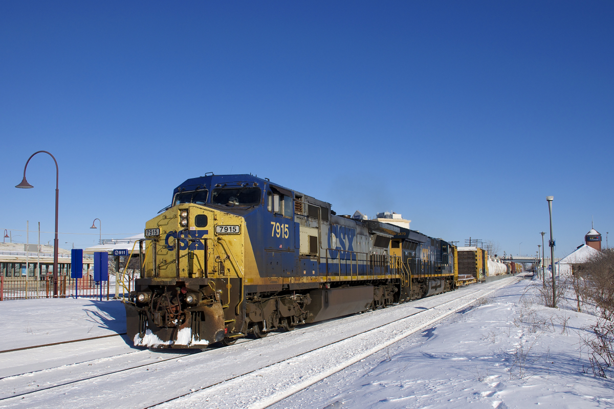 CSXT 7915 & CSXT 3470 (built by GE 24 years apart) lead an 88-car CN 327 past the stations at Dorval on a frigid but sunny afternoon.
